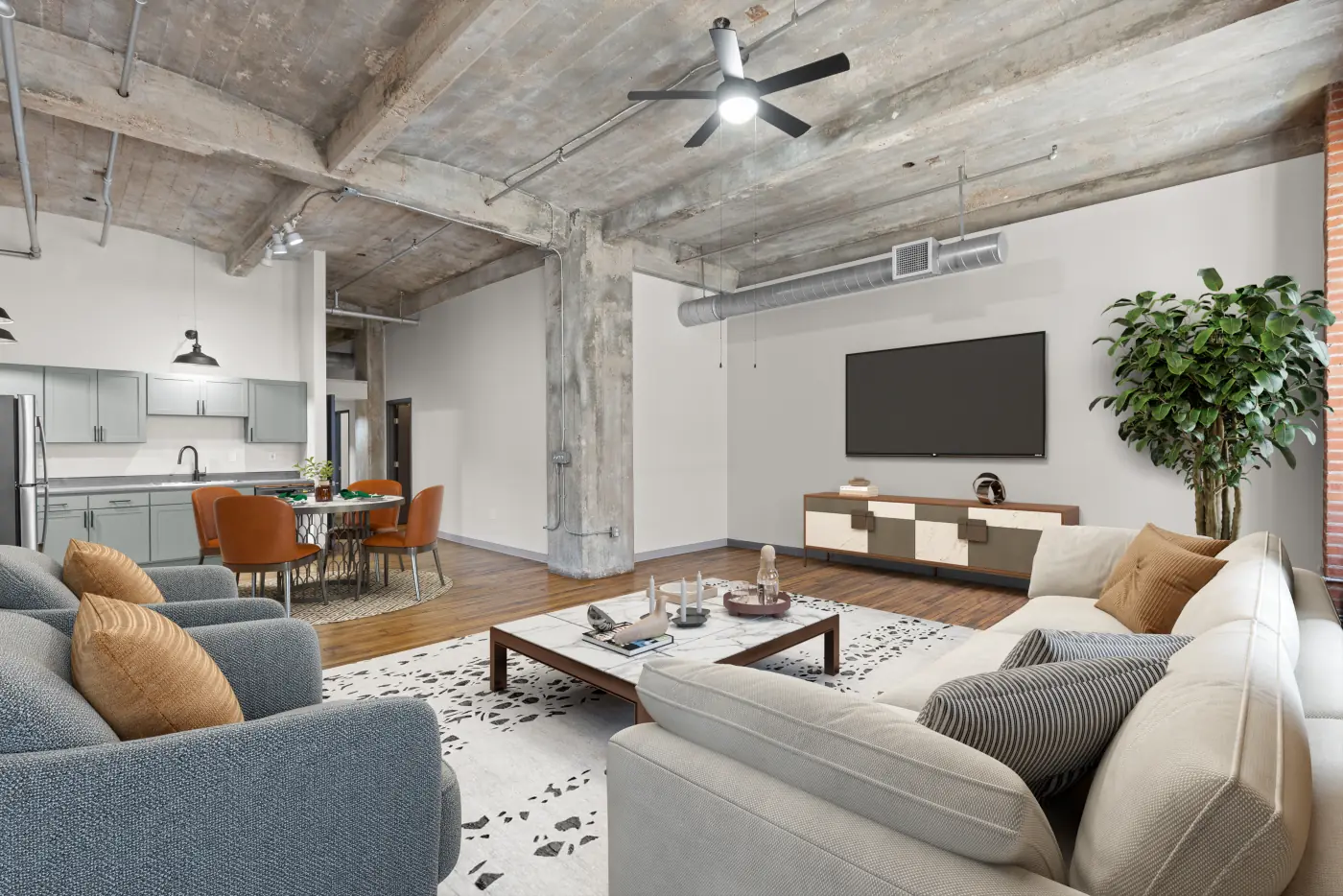 Open-plan loft living, dining and kitchen with concrete columns