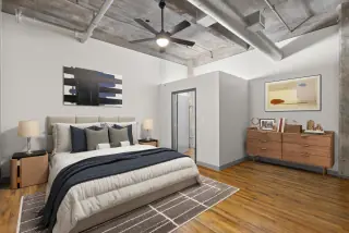 Bedroom under concrete beams and exposed ductwork