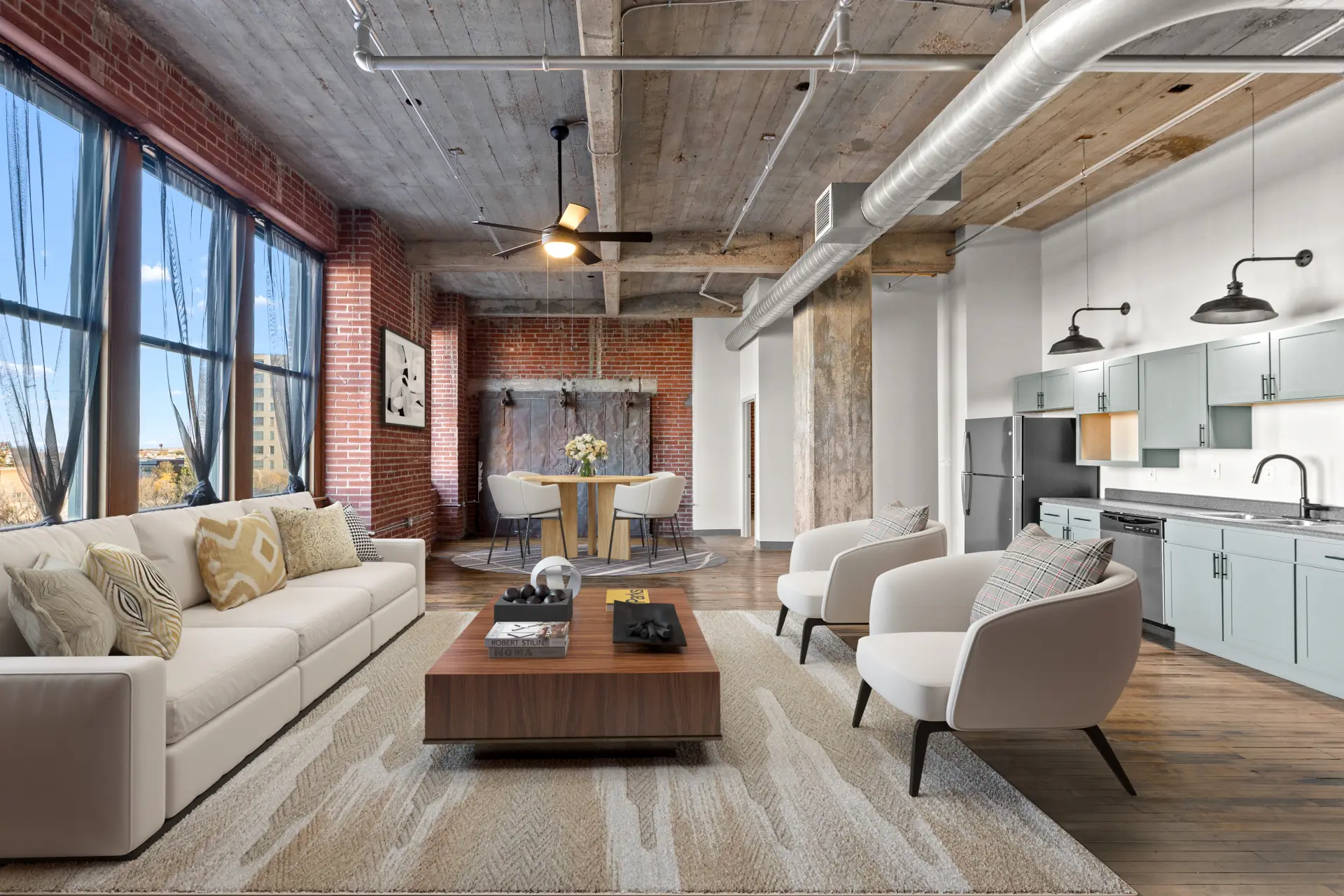Vista loft living room with exposed brick, concrete ceilings and a wall of windows