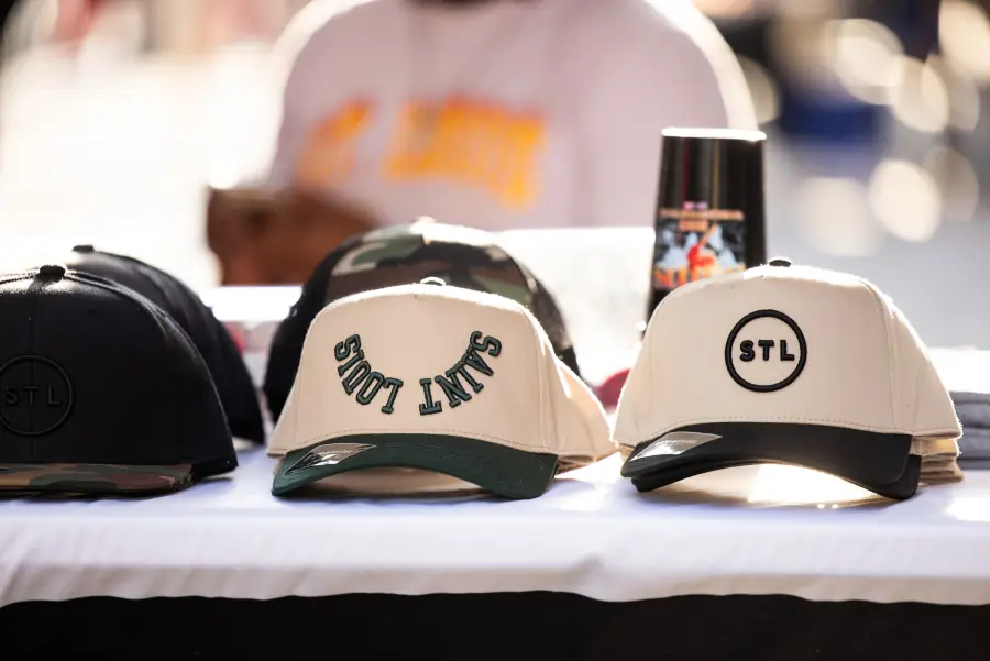 Saint Louis caps on a stallholder&rsquo;s table at a Washington Avenue market