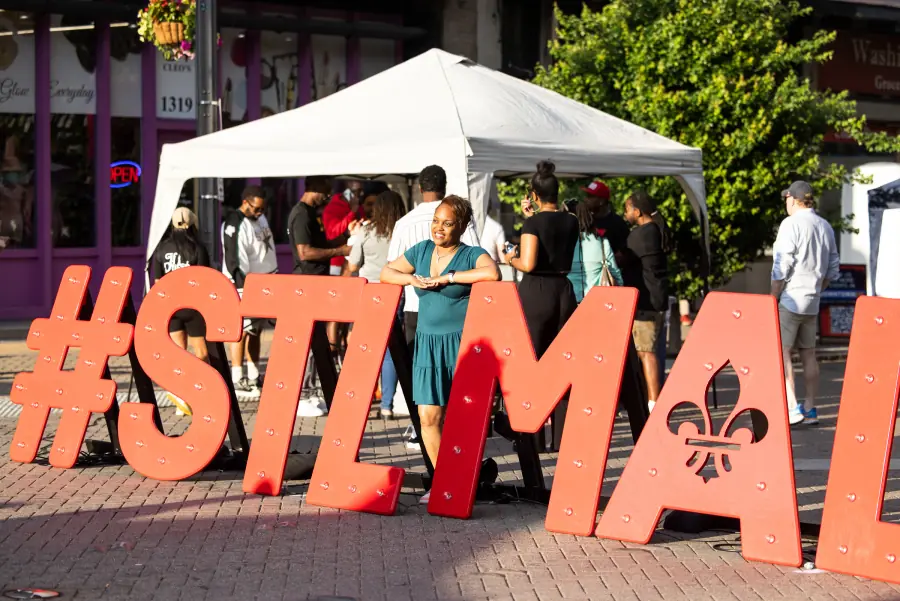 Oversized #STLMADE letters beside a market tent on Washington Avenue